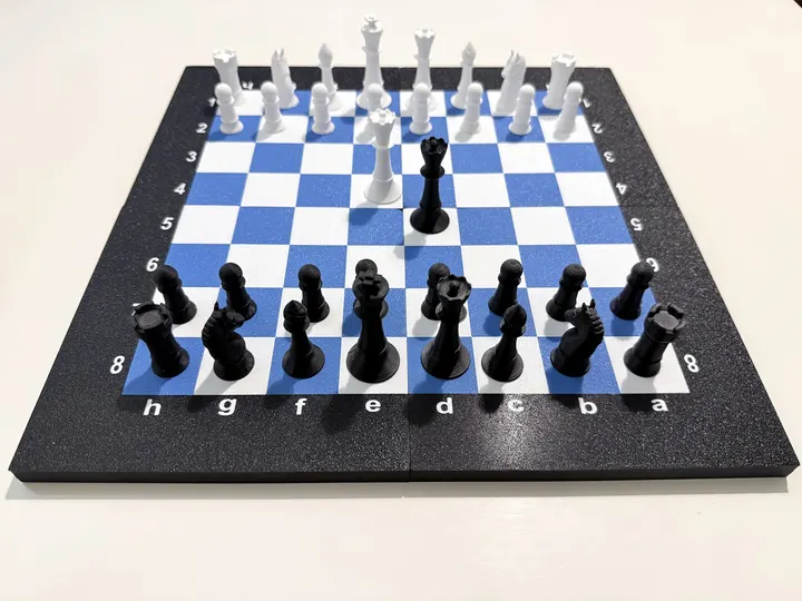 An early test print of the board in black, white and blue, with 3D printed pieces on it